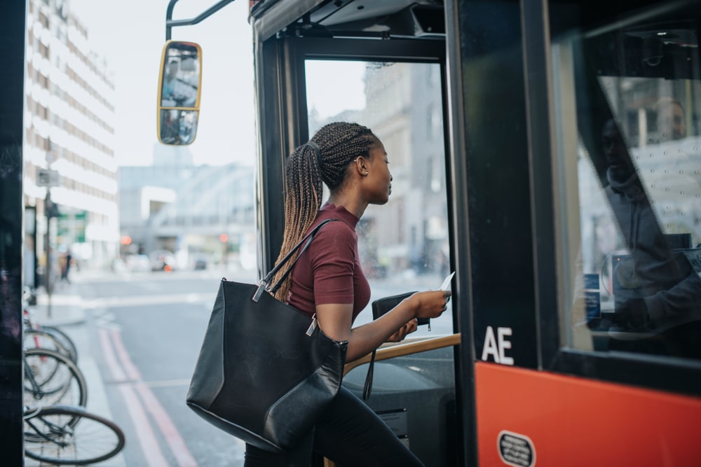 Image of a woman getting on a bus